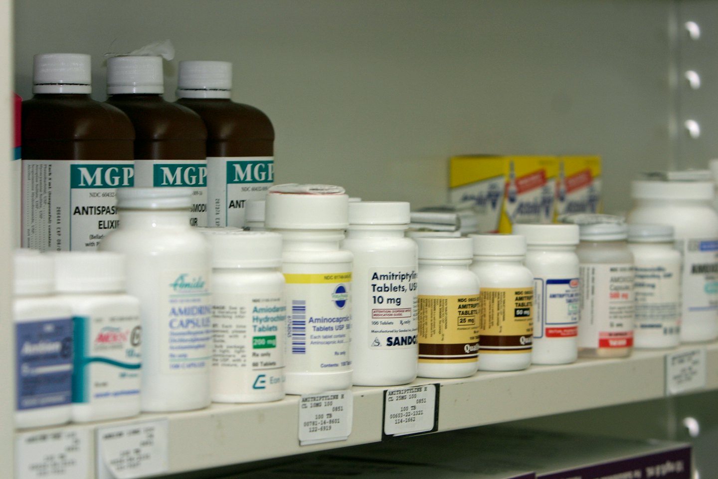Shelves stocked with prescription medication bottles and boxes.